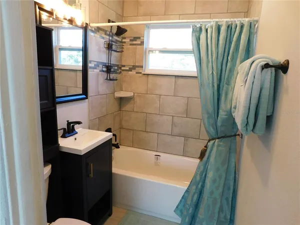a bathroom with a sink a bathtub and a shower