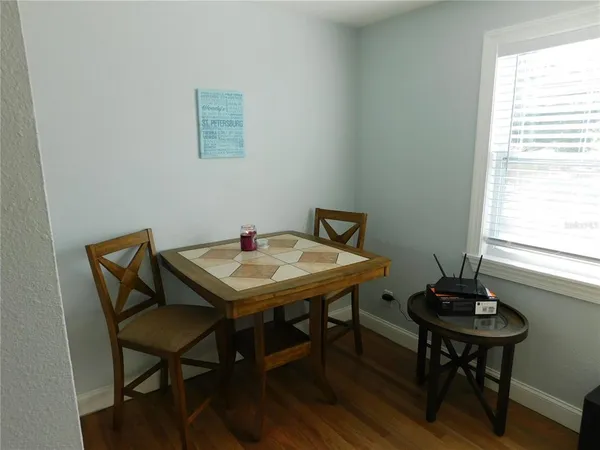 a view of a room that has a table and chairs in it