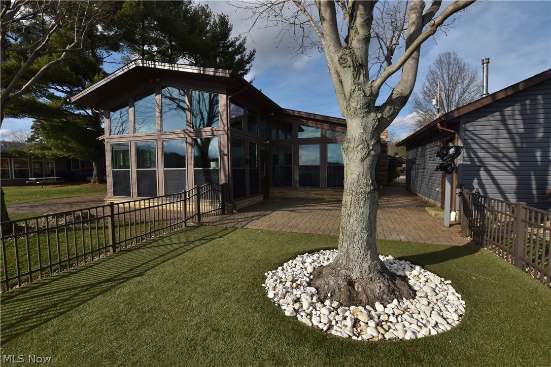 1251 Arrowhead Drive Southwest Dellroy, OH 44620 - Photo 6 of 50 A wraparound lake view paver patio provides the ideal setting for outdoor living and entertaining