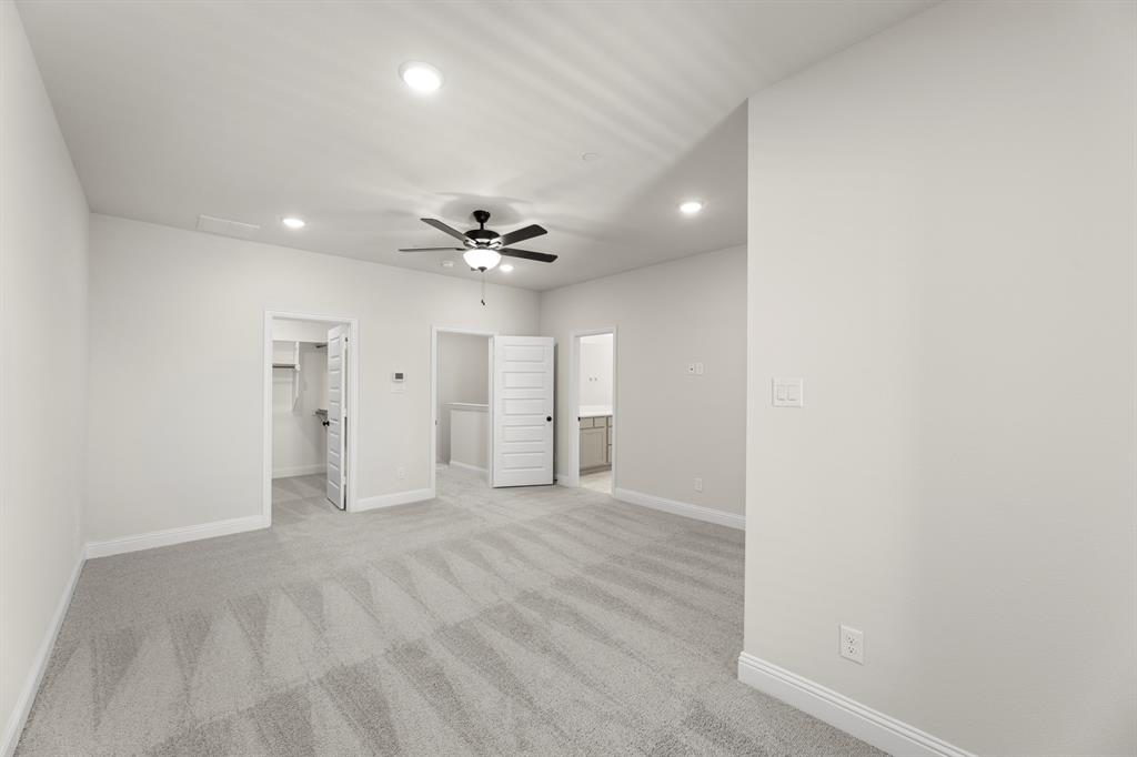 3916 Keya Drive Prosper, TX 75078 - Photo 19 of 28 a view of an empty room and a chandelier fan