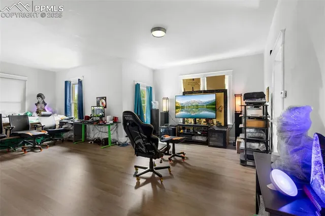 a living room with furniture gym equipment and a flat screen tv