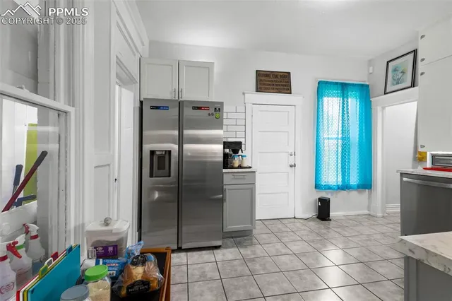 a kitchen with stainless steel appliances a refrigerator and a counter top space