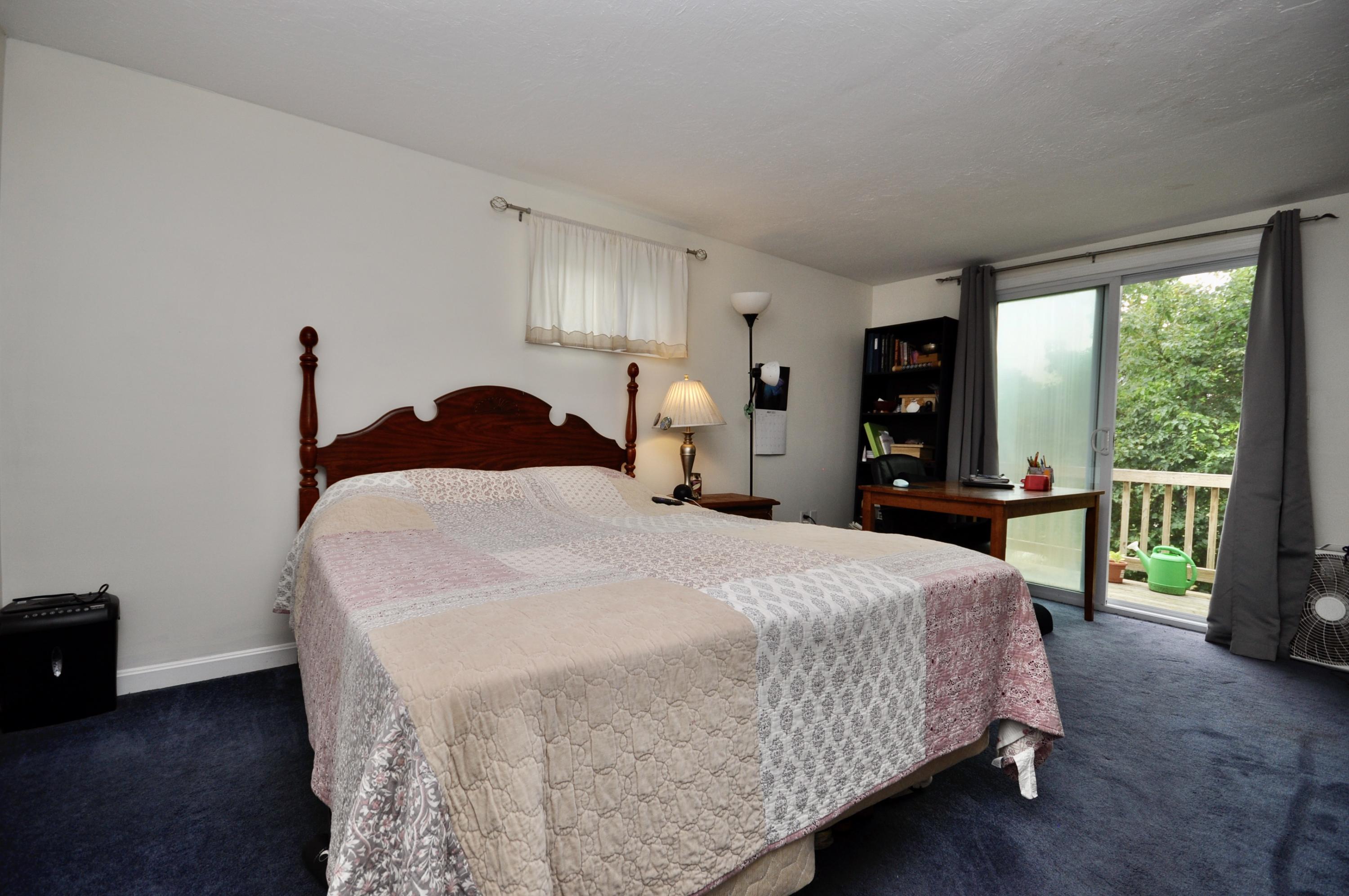 401 Village Drive Bourne, MA 02532 - Photo 11 of 22 a bedroom with a bed and a large window