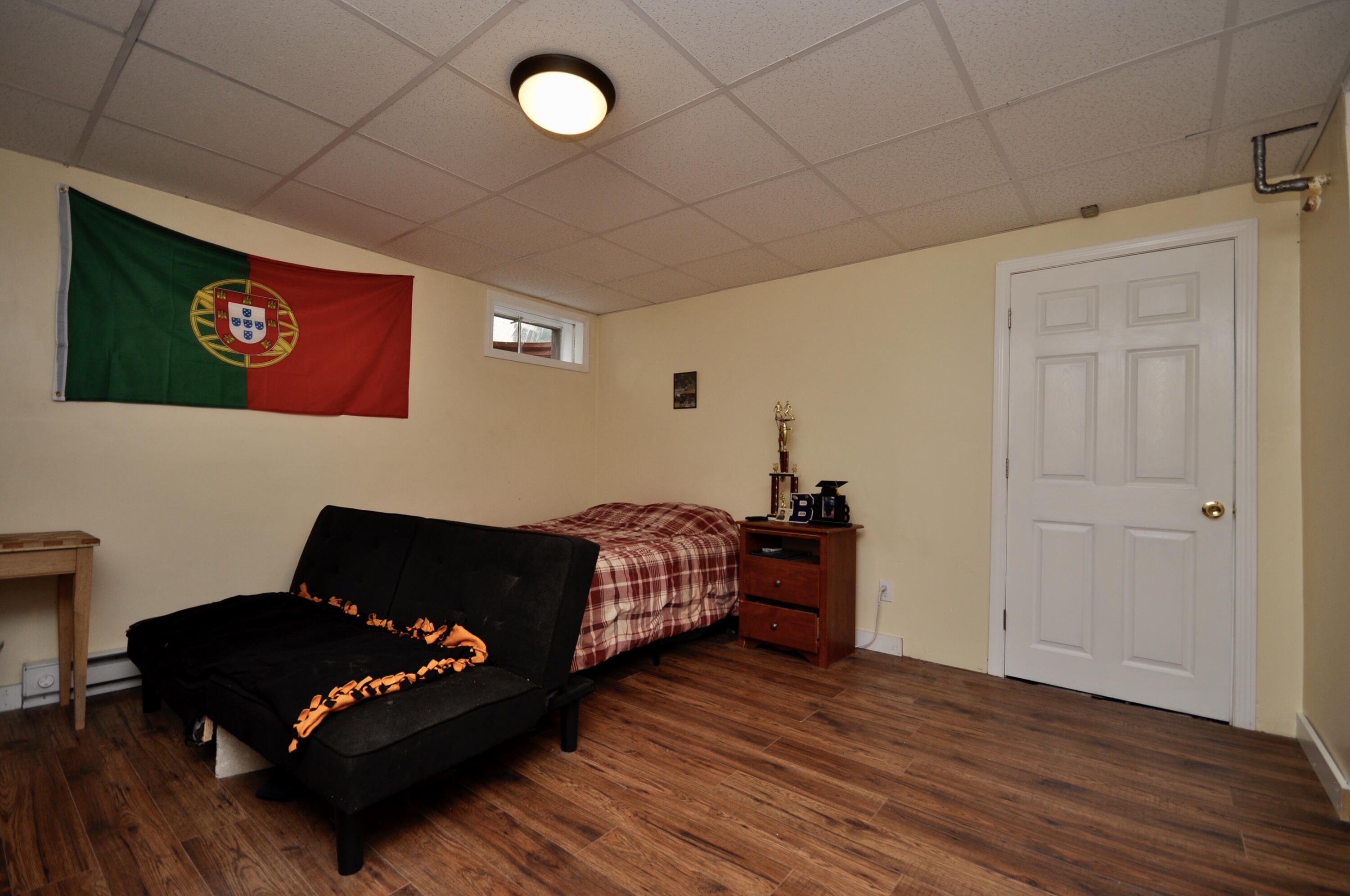 401 Village Drive Bourne, MA 02532 - Photo 17 of 22 a living room with furniture rug and wooden floor