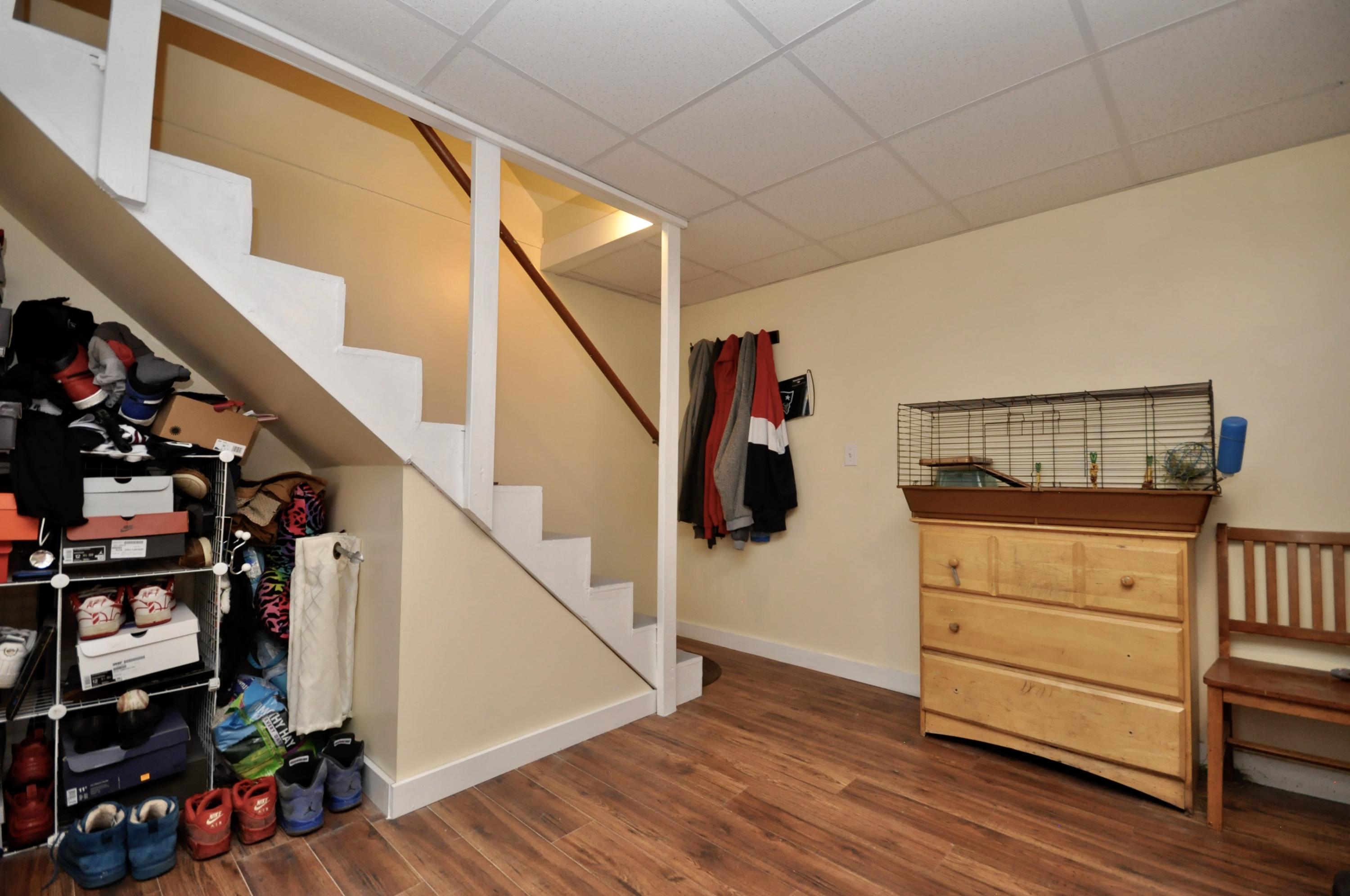 401 Village Drive Bourne, MA 02532 - Photo 18 of 22 a view of a hallway with wooden floor and stairs