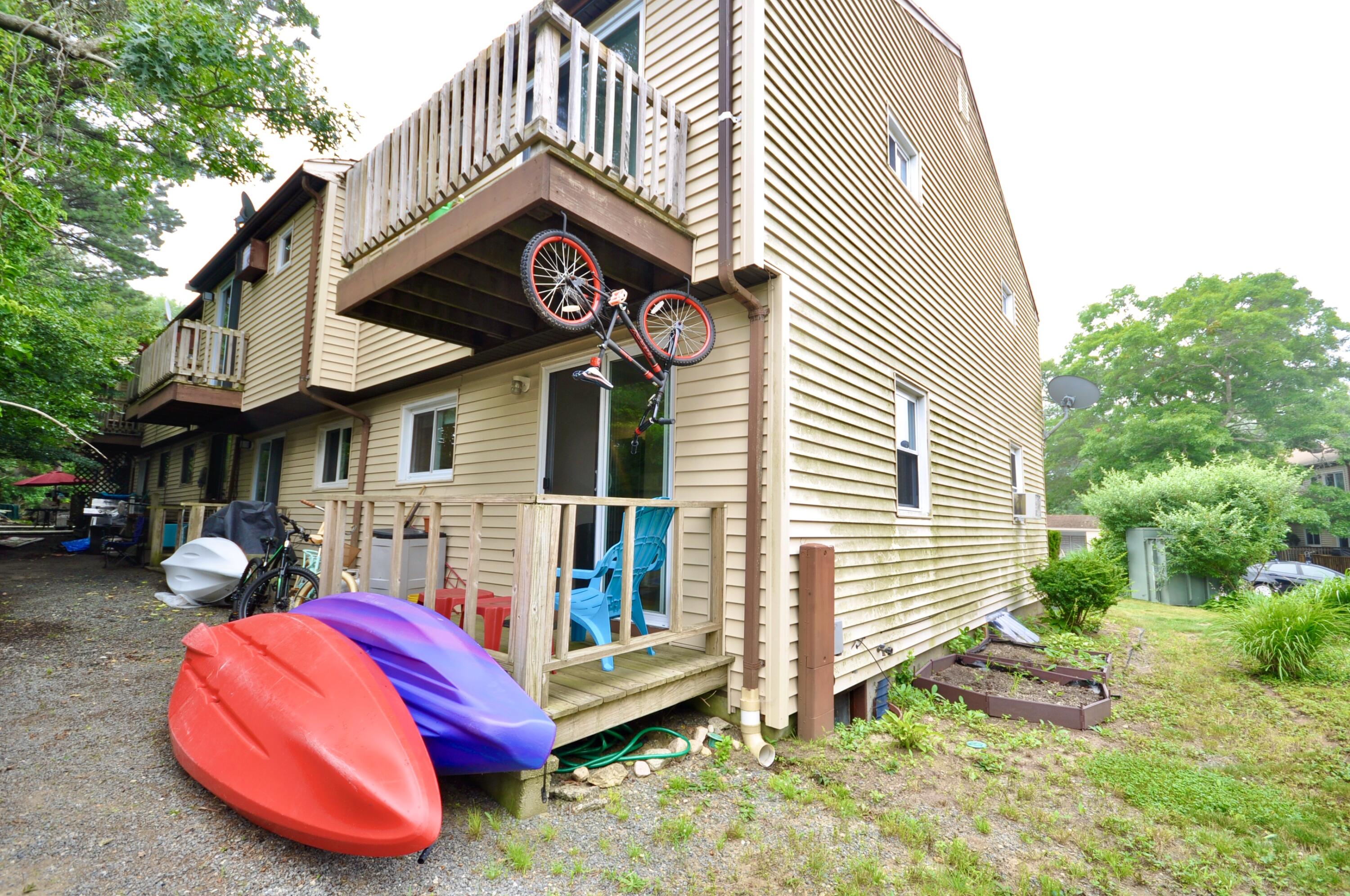 401 Village Drive Bourne, MA 02532 - Photo 20 of 22 a view of a house with a yard and sitting area