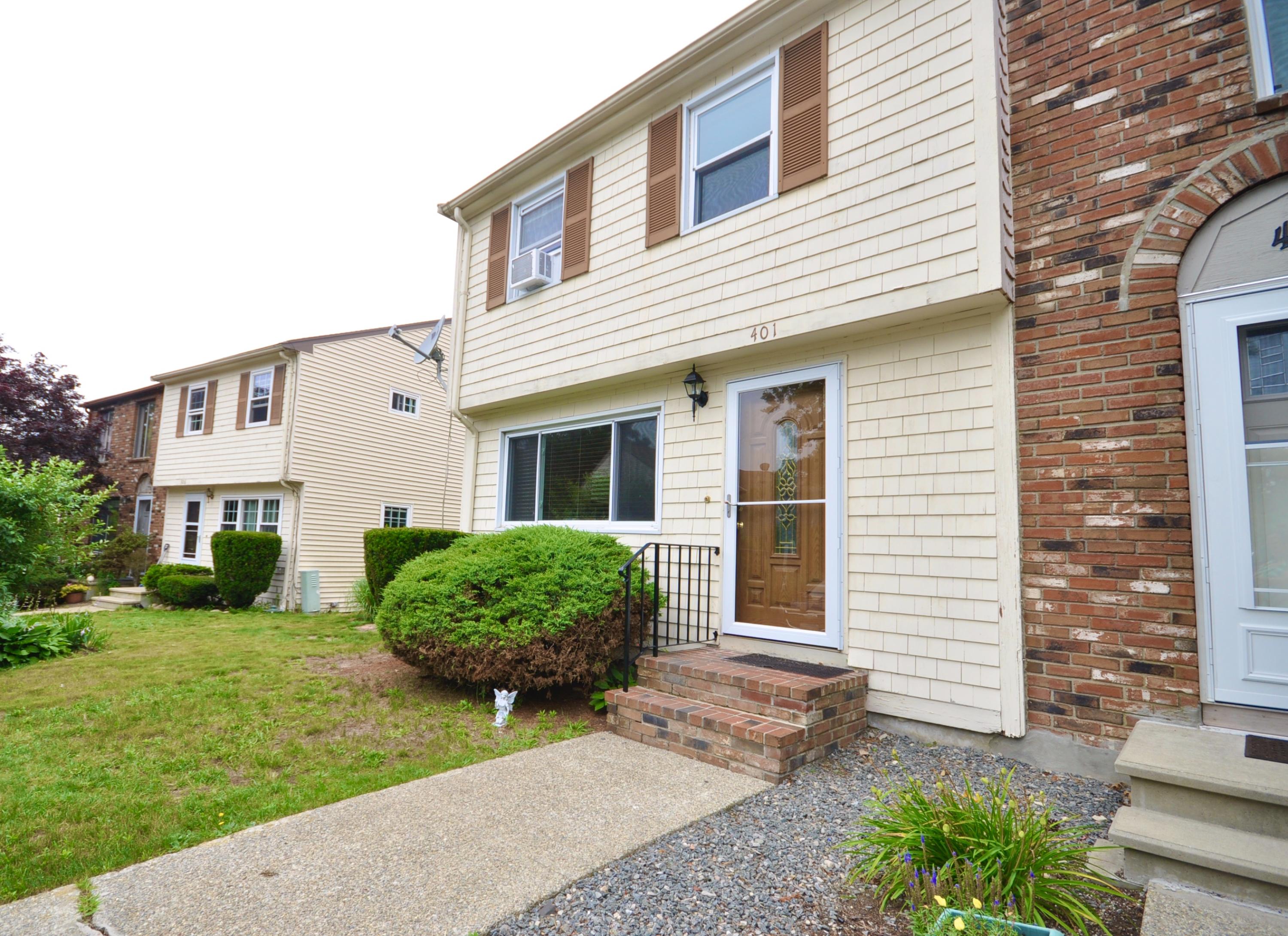 401 Village Drive Bourne, MA 02532 - Photo 2 of 22 a front view of a house with garden