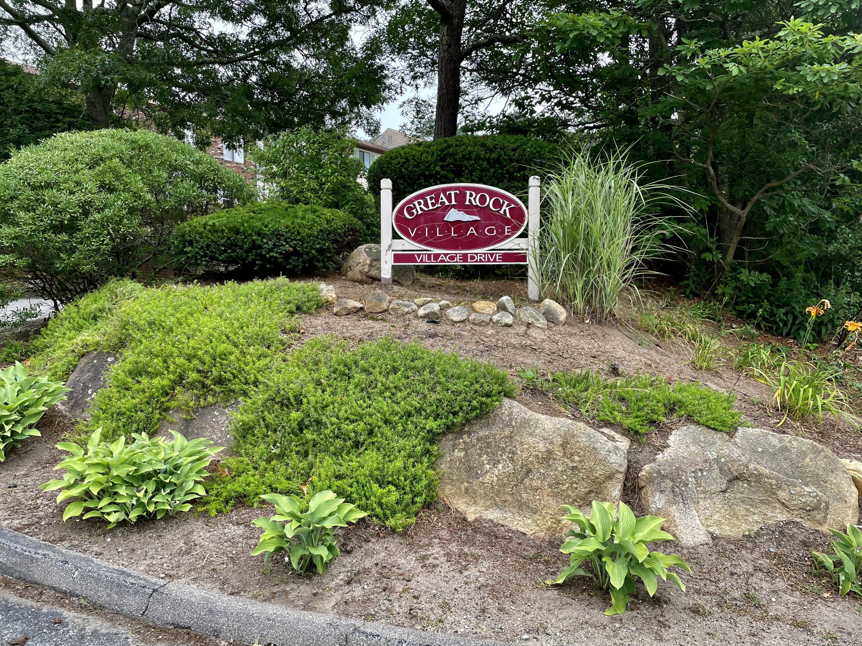 401 Village Drive Bourne, MA 02532 - Photo 22 of 22 a sign that is sitting in front of flowers