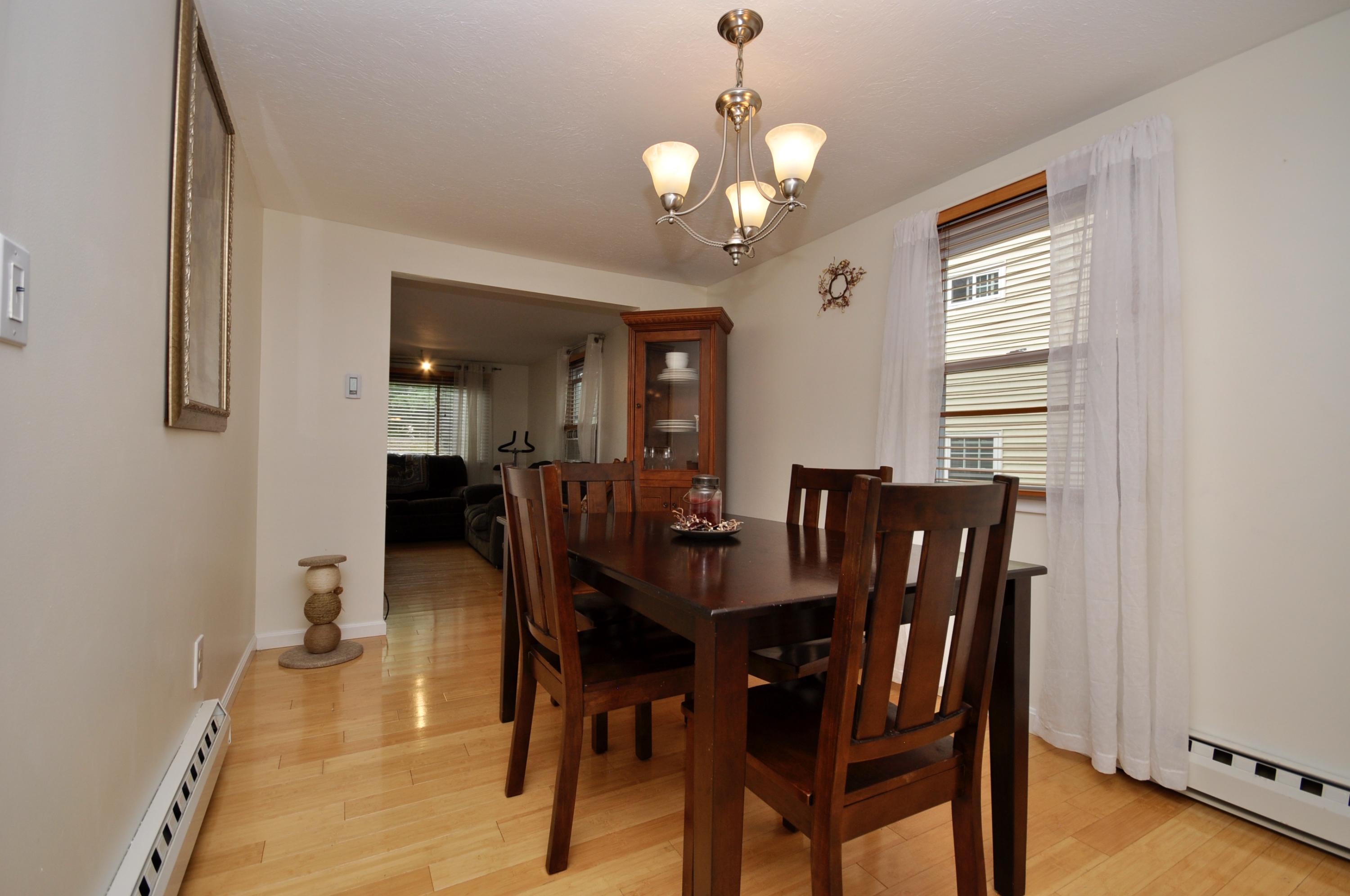 401 Village Drive Bourne, MA 02532 - Photo 8 of 22 a view of a dining room with furniture and wooden floor