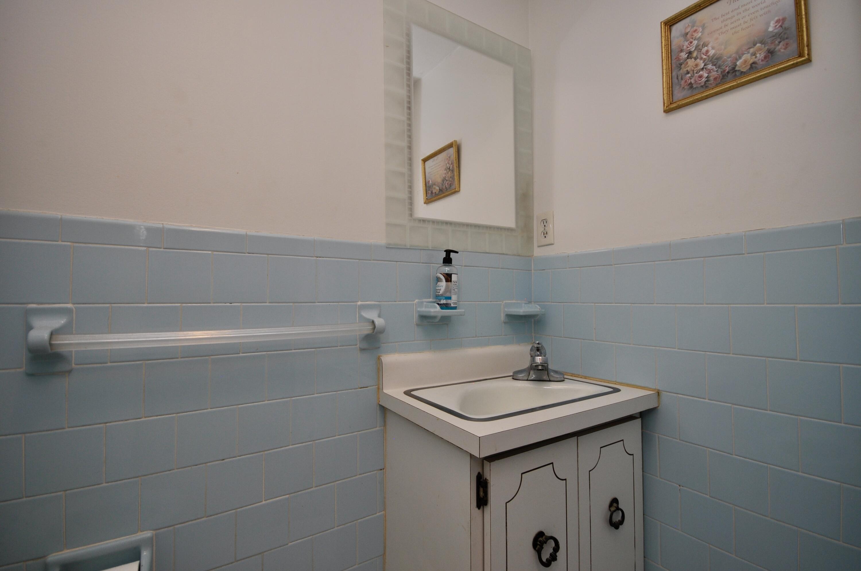 401 Village Drive Bourne, MA 02532 - Photo 10 of 22 a bathroom with a sink and a mirror