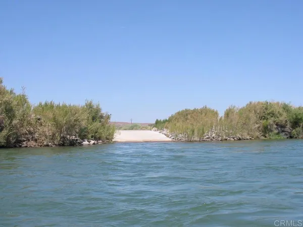 a view of an ocean beach and mountains