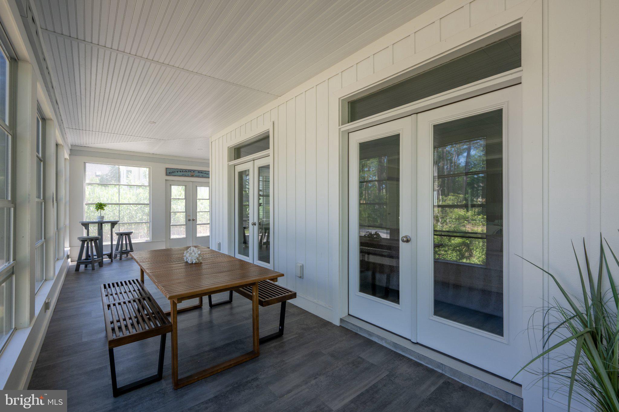 402 Salt Pond Road Bethany Beach, DE 19930 - Photo 11 of 55 Serene sunlit porch retreat.