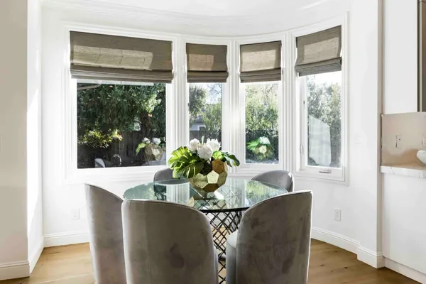 a dining room with furniture wooden floor and a potted plant