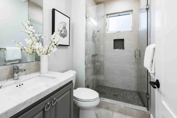 a bathroom with a sink a toilet and shower