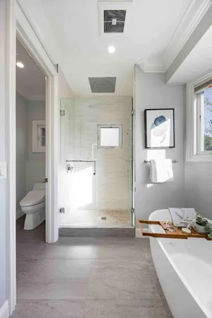 a view of a bathroom with a tub and shower