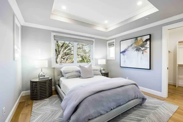 a bedroom with a bed and a painting on the wall