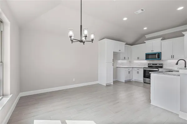 a view of a kitchen with electric appliances