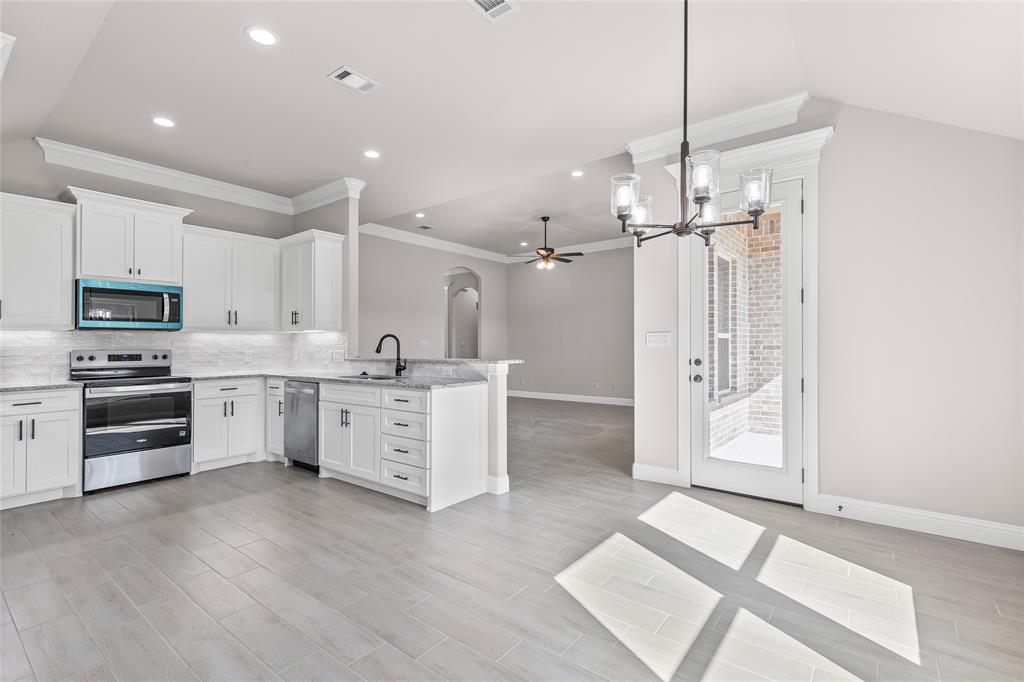 620 Jameson Springtown, TX 76082 - Photo 18 of 37 a large white kitchen with a refrigerator a stove a sink and a cabinets