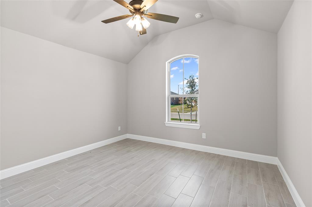 620 Jameson Springtown, TX 76082 - Photo 22 of 37 an empty room with wooden floor chandelier fan and windows