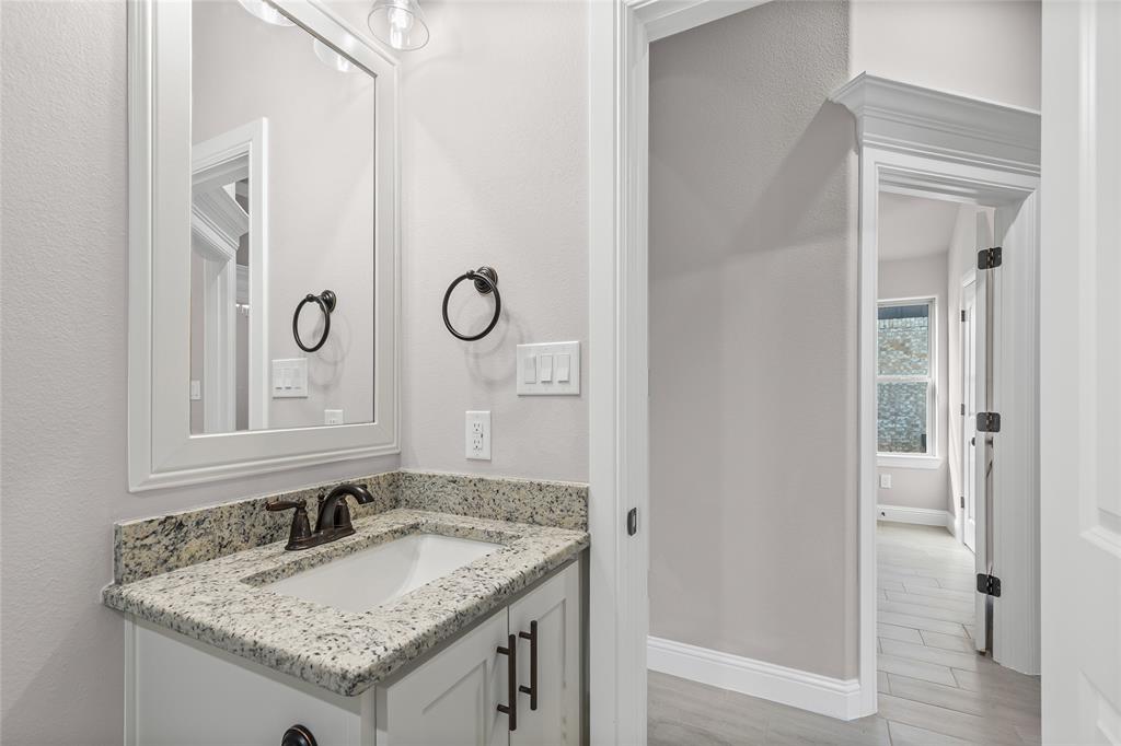 620 Jameson Springtown, TX 76082 - Photo 29 of 37 a bathroom with a granite countertop sink and a mirror