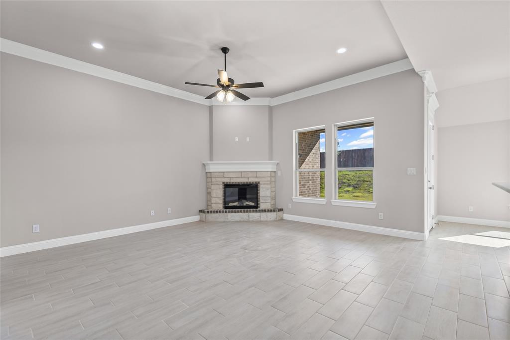 620 Jameson Springtown, TX 76082 - Photo 8 of 37 an empty room with windows fireplace and fans