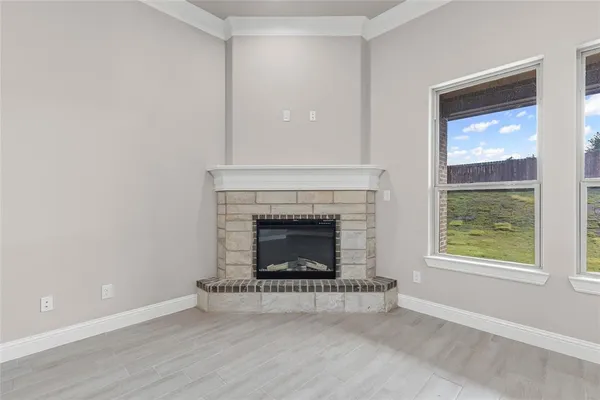 a living room with a fireplace and a window