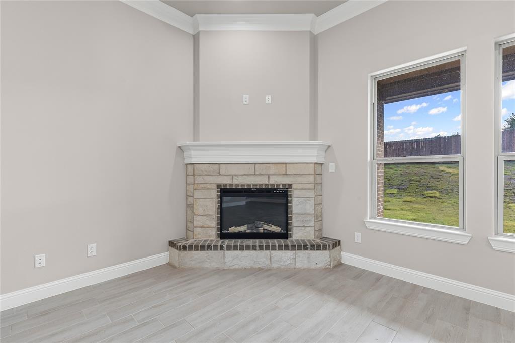 620 Jameson Springtown, TX 76082 - Photo 10 of 37 a living room with a fireplace and a window