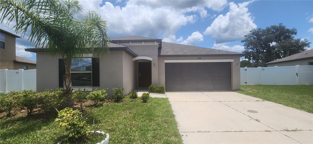 3188 Nubbin Ridge Lane Zephyrhills, FL 33540 - Photo 1 of 1 a front view of a house with garden