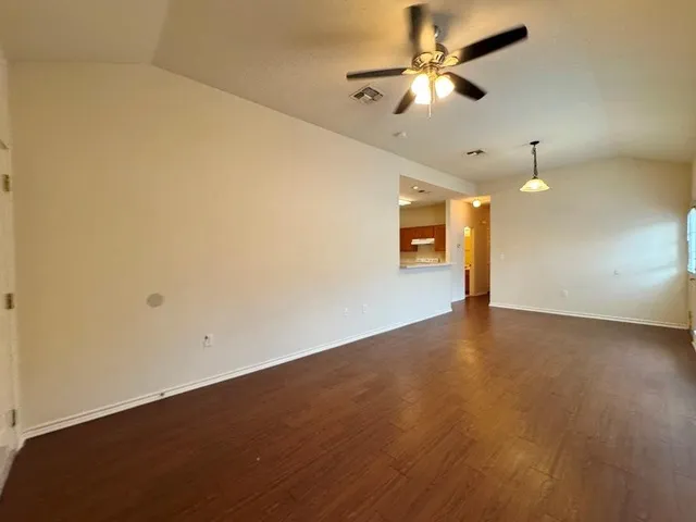 an empty room with a empty space and a ceiling fan