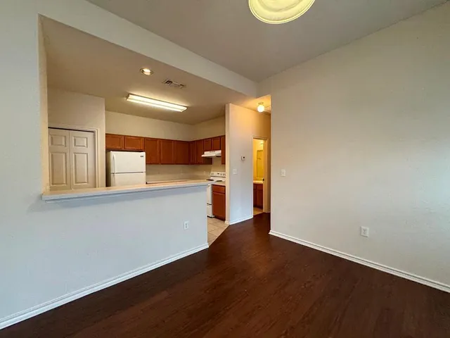 a room with wooden floor and a window