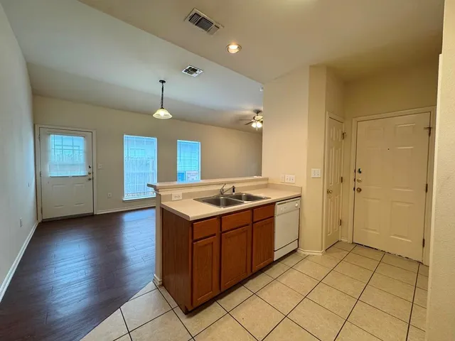 a large kitchen with granite countertop a stove and a sink