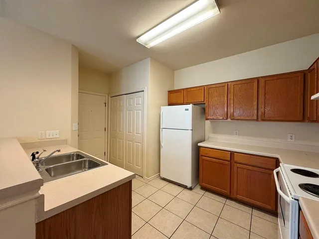 a kitchen with a cabinets and white appliances