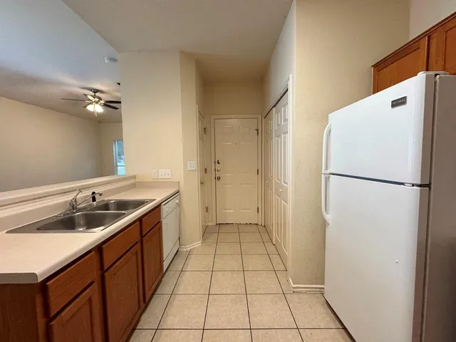 a kitchen with a sink and a refrigerator