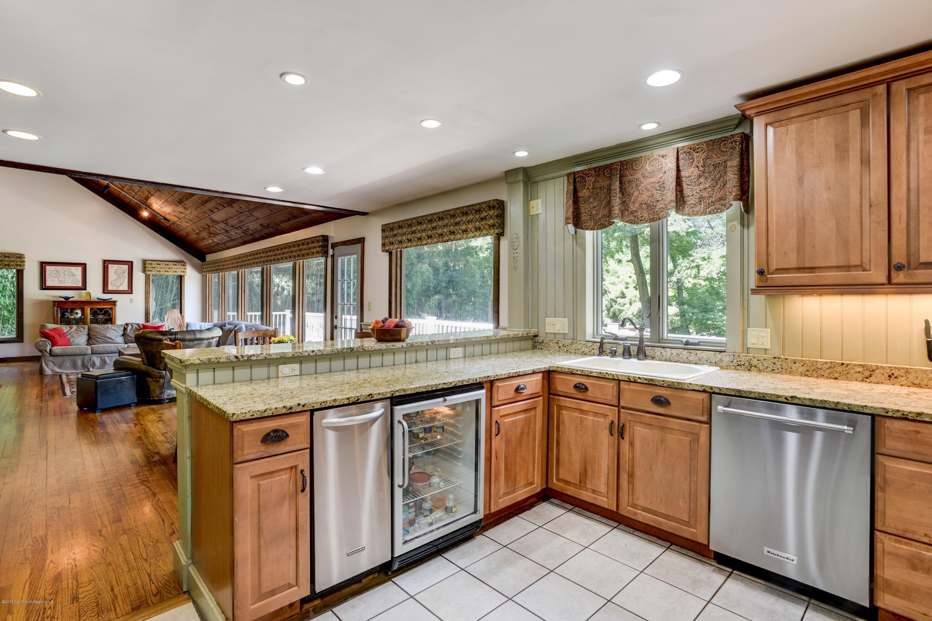 45 Heyers Mill Road Colts Neck, NJ 07722 - Photo 16 of 36 a open kitchen with lots of counter space sink and wooden floor