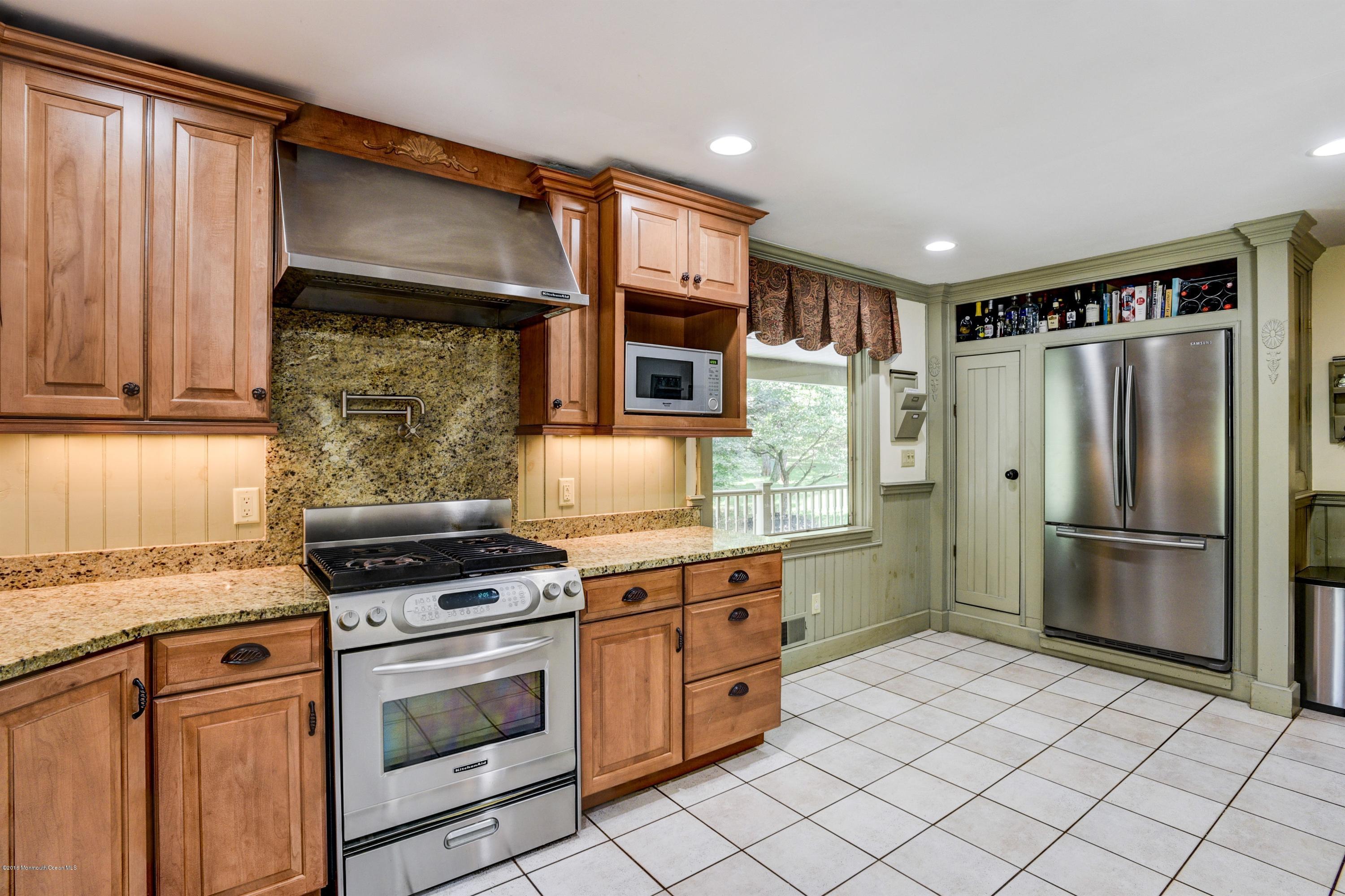 45 Heyers Mill Road Colts Neck, NJ 07722 - Photo 17 of 36 a kitchen with stainless steel appliances granite countertop a cabinets and a stove top oven