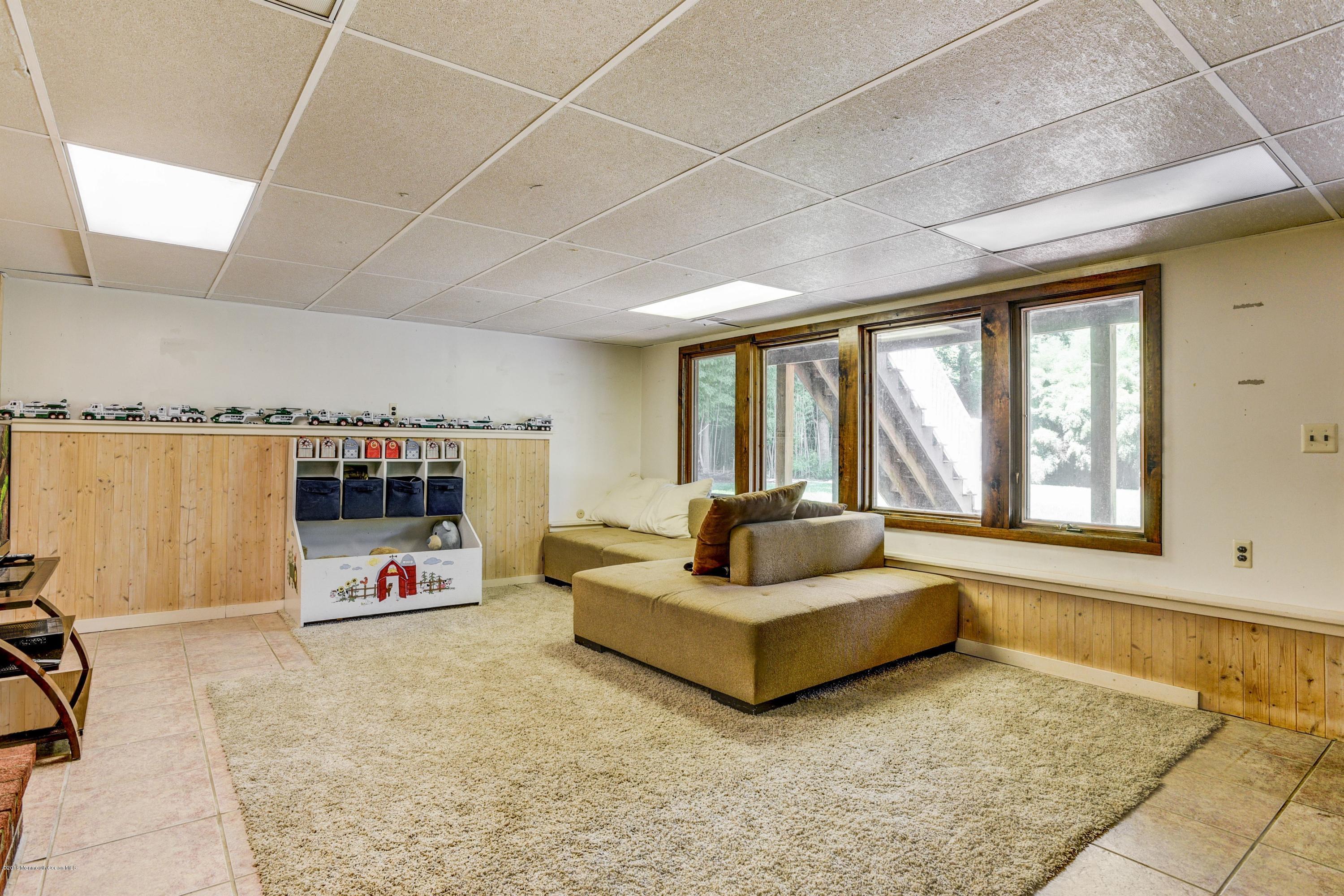 45 Heyers Mill Road Colts Neck, NJ 07722 - Photo 29 of 36 a living room with furniture and a flat screen tv