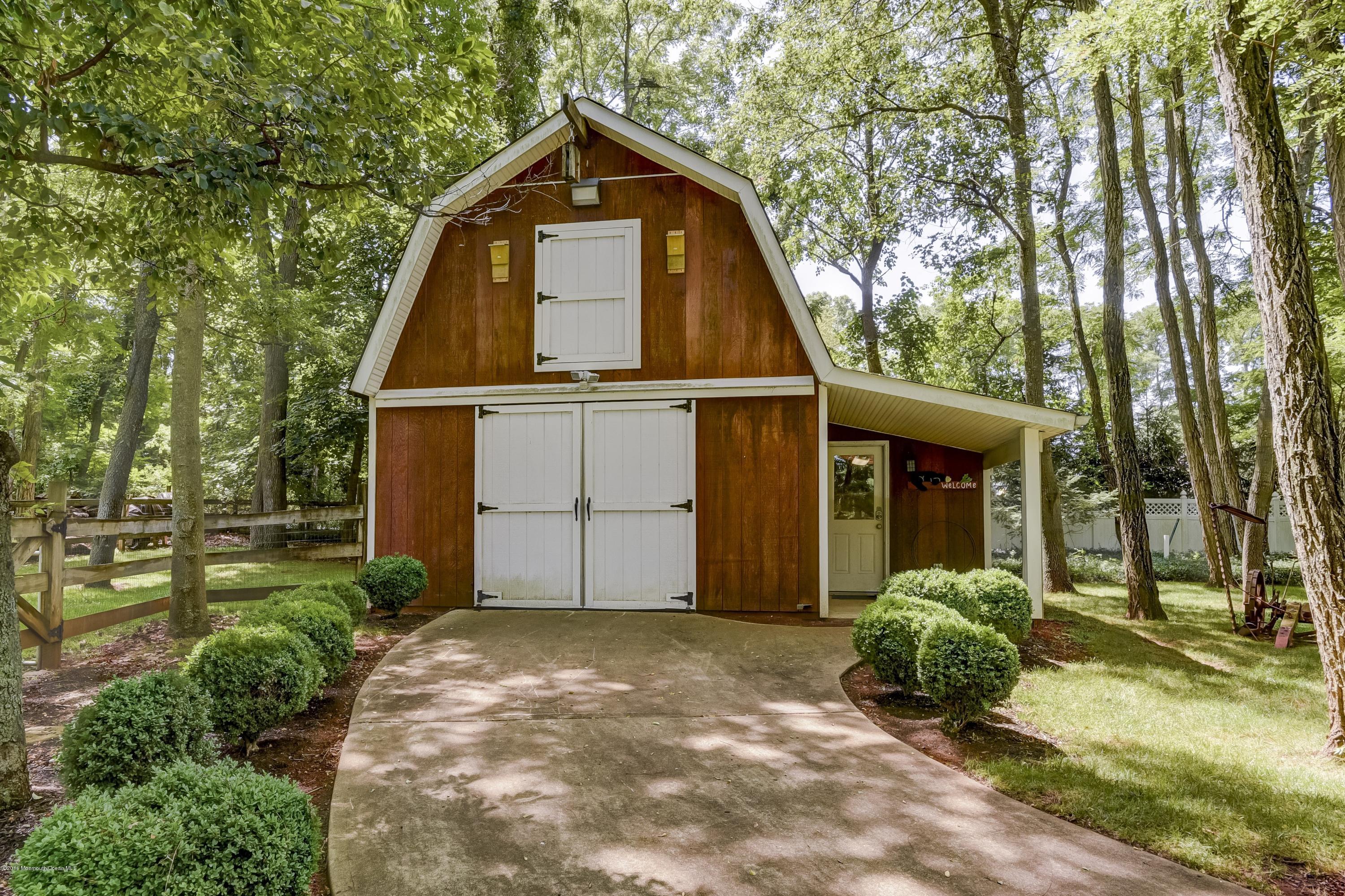 45 Heyers Mill Road Colts Neck, NJ 07722 - Photo 4 of 36 a front view of a house with a yard