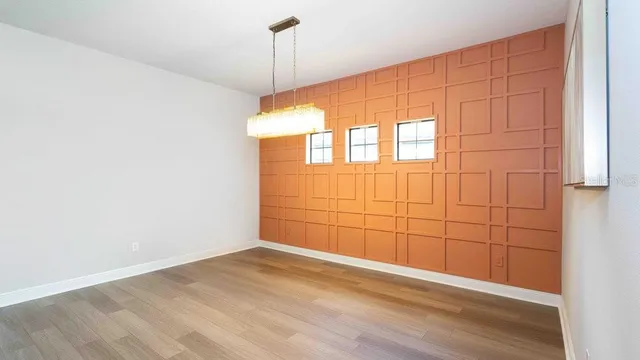 an empty room with a ceiling fan