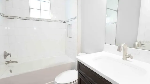 a view of a hallway with a sink and a window
