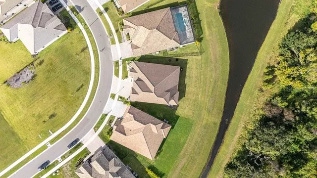an aerial view of a house with a swimming pool