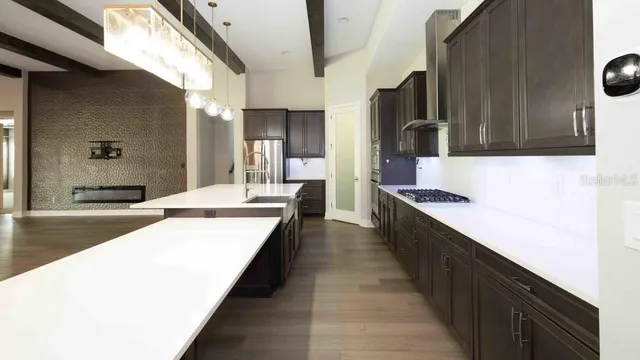 a large kitchen with kitchen island granite countertop a large counter top and sink