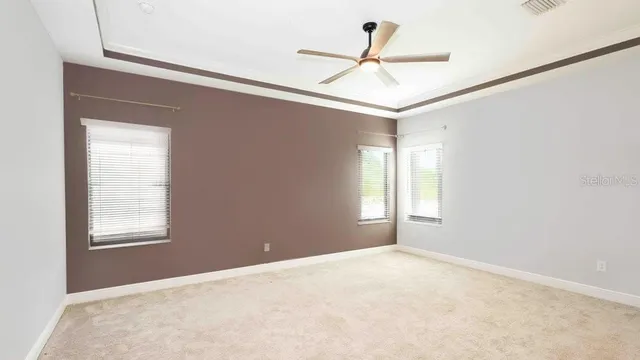 a view of a livingroom with a ceiling fan and window