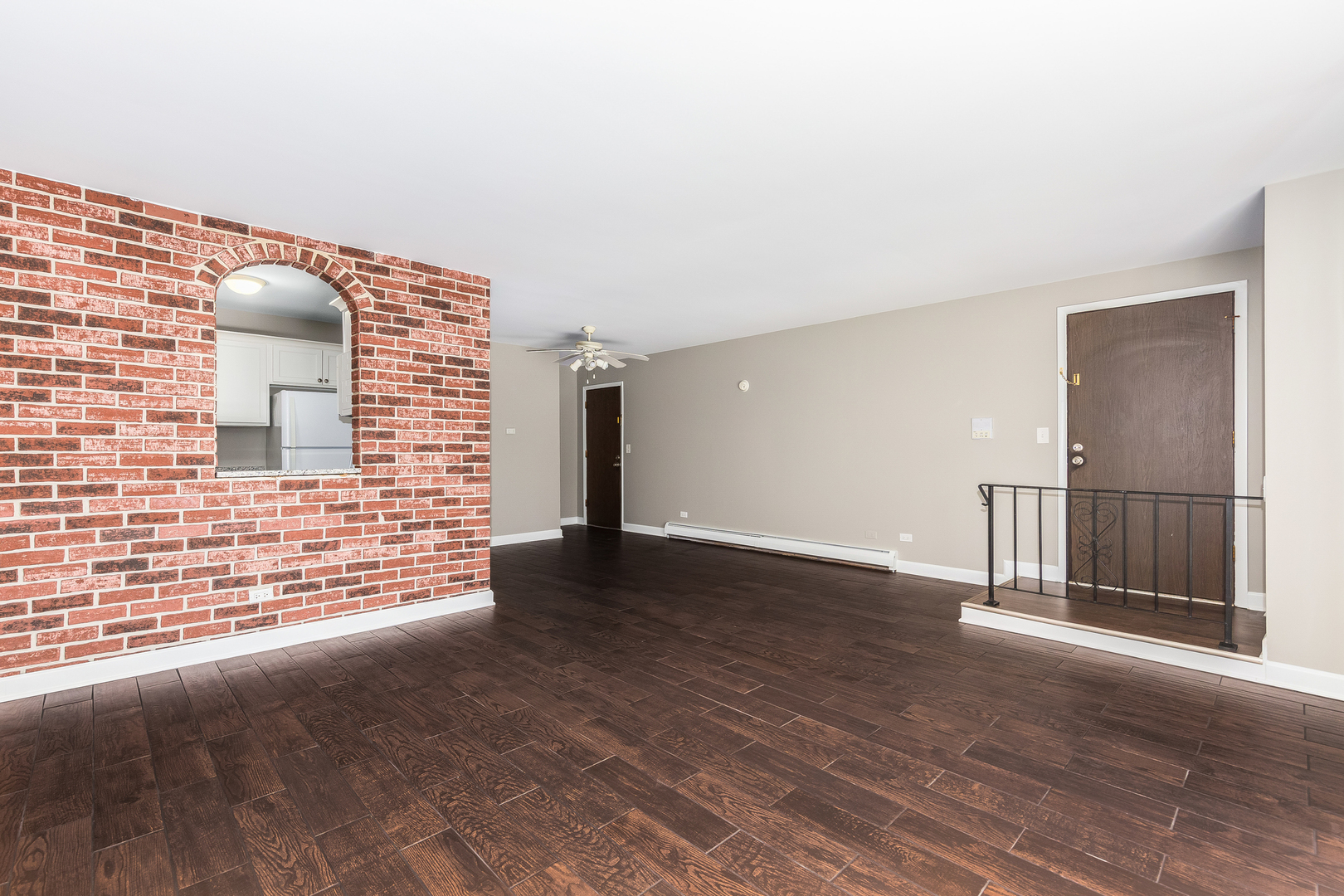 2525 Spring Street, Unit 2806 Woodridge, IL 60517 - Photo 7 of 16 a view of an empty room with wooden floor and a window