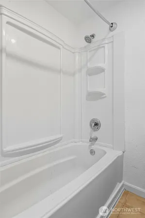 a bathroom with a bathtub and a shower