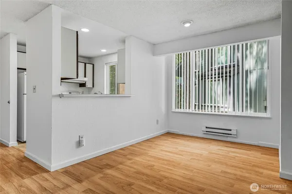 a view of a livingroom with wooden floor and a window