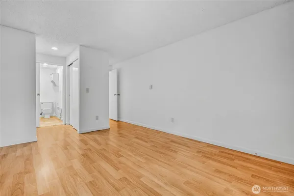 a view of an empty room and wooden floor