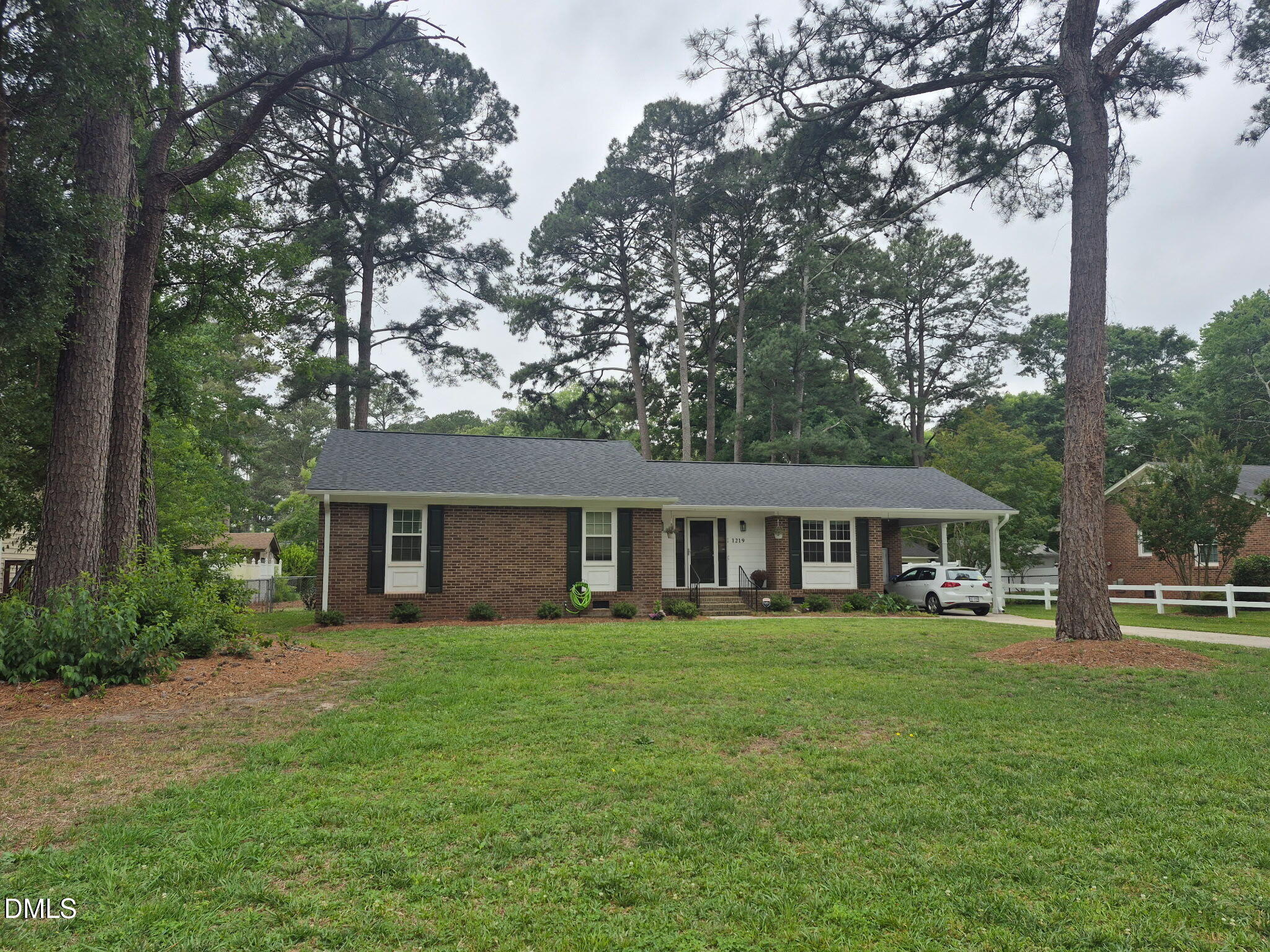 1219 Queen Anne Road Northwest Wilson, NC 27896 - Photo 15 of 26 a front view of a house with a garden