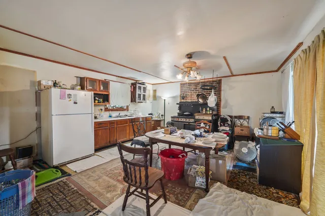 a kitchen with a refrigerator and a stove top oven