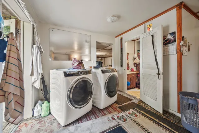 a utility room with sink dryer and washer