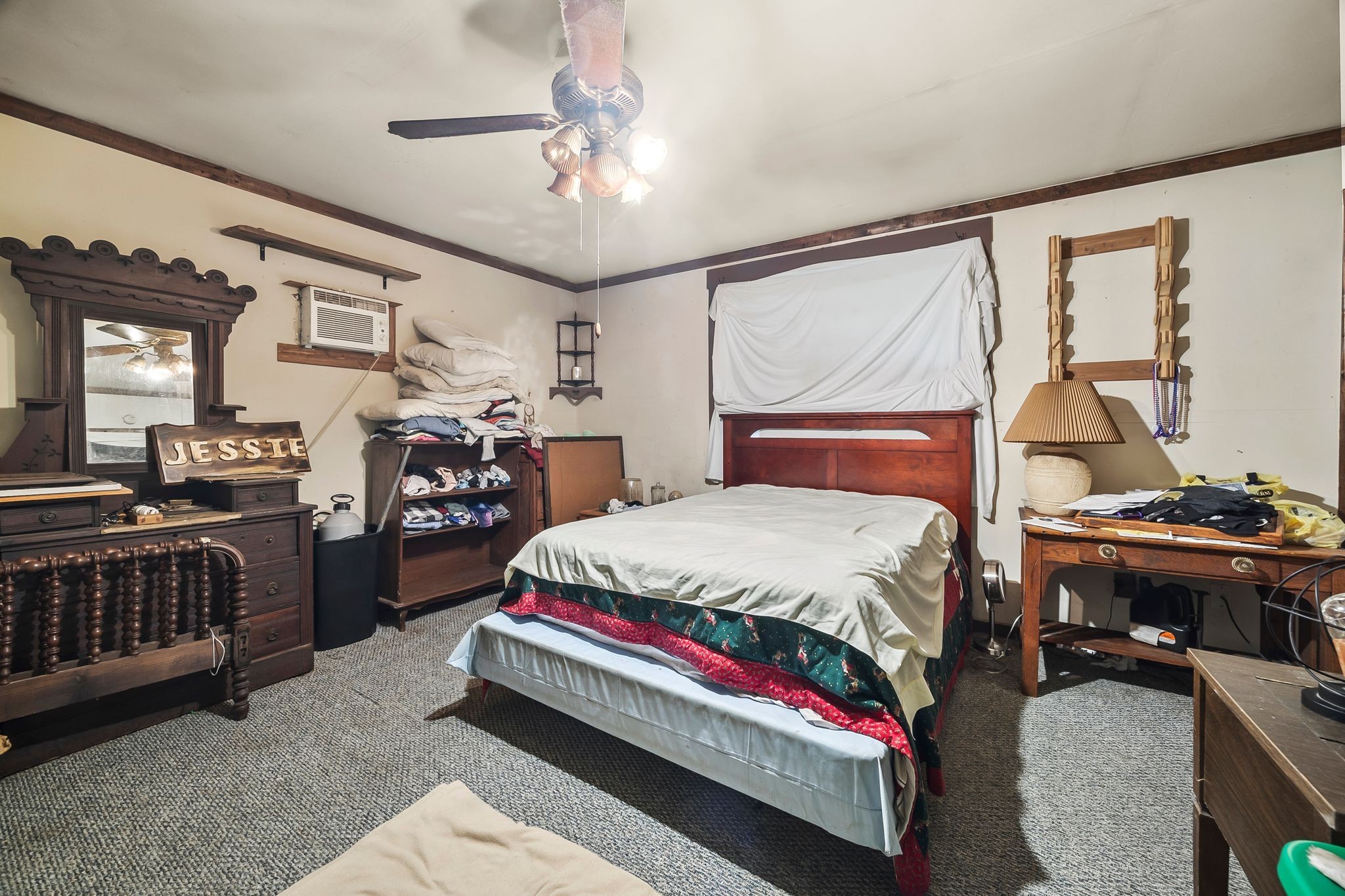 1150 Bell Hollow Road Vanleer, TN 37181 - Photo 22 of 32 a bedroom with a bed and a chandelier